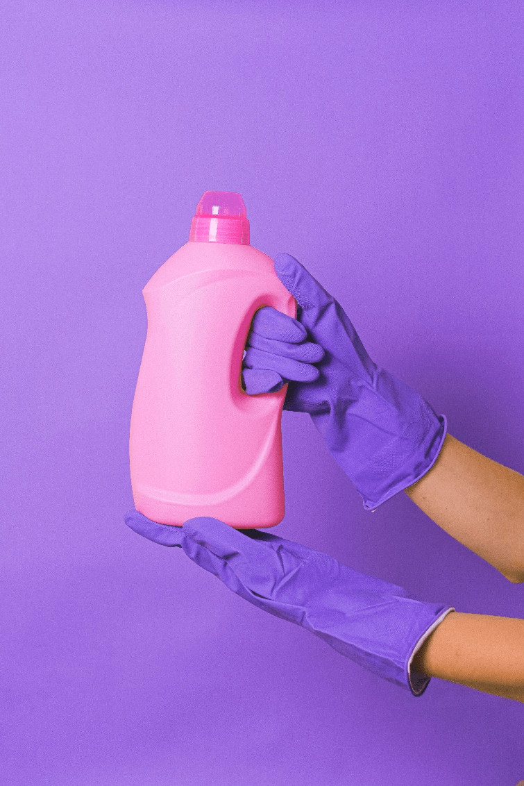 a person holding up a detergent 
